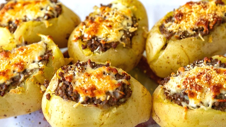 Close-up of baked potatoes filled with ground beef and topped with melted cheese