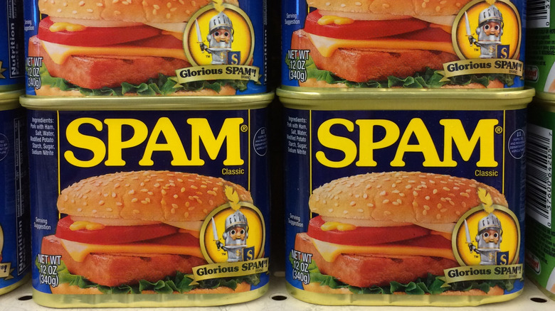 Cans of Spam stacked at the grocery store.