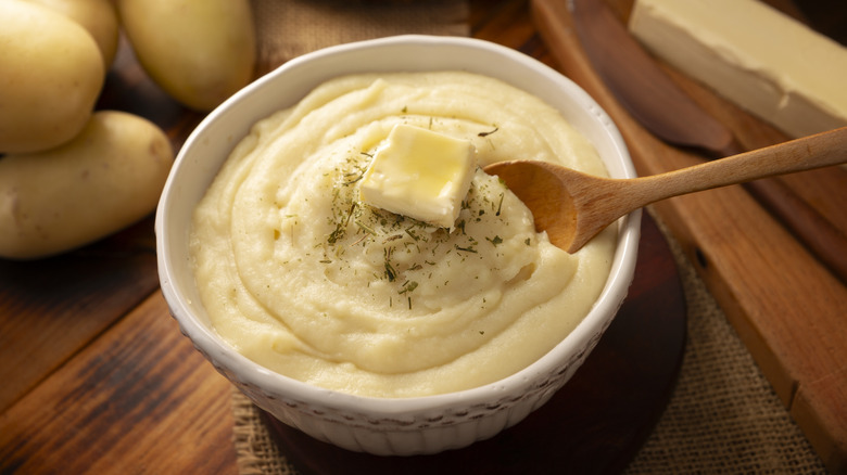 bowl of mashed potatoes topped with butter