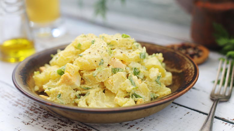 wooden bowl full of traditional potato salad