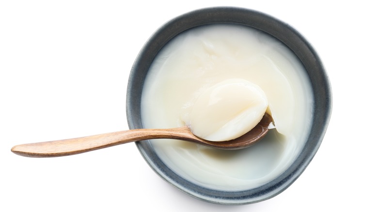 wooden spoon in bowl of fat