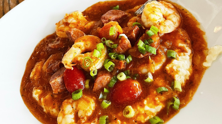 Shrimp and grits with tomato sauce and cherry tomatoes