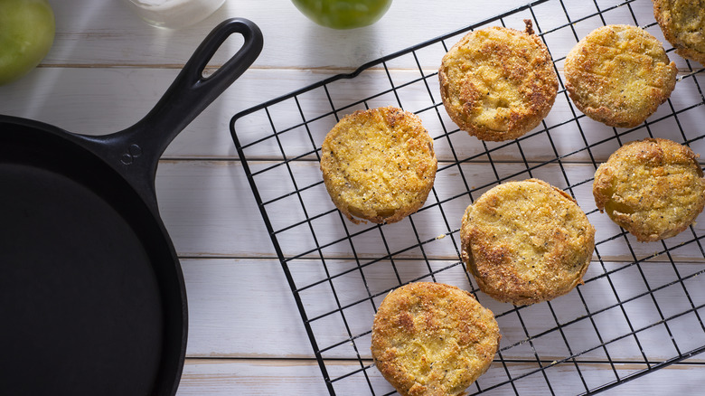 fried green tomatoes on a cooling rack