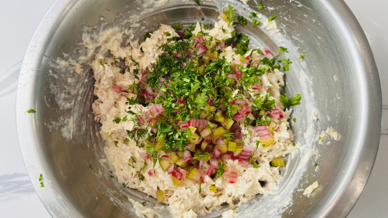 Tuna salad with herbs and pickled veggies in a stainless steel bowl