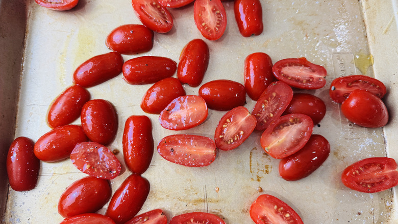 Seasoned grape tomatoes on baking sheet