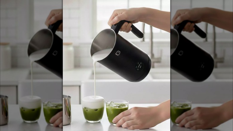 Person pouring milk into a matcha glass from a Willow Kitchen Cordless Electric Milk Frother & Steamer
