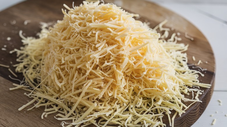 grated cheese on a wooden board
