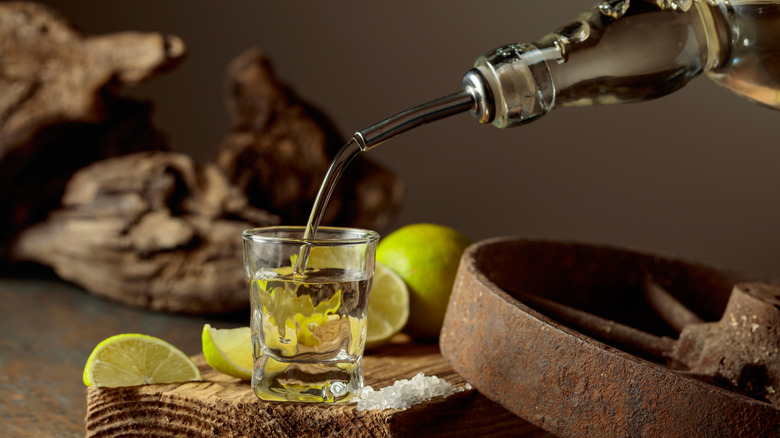 Tequila being poured into a shot glass