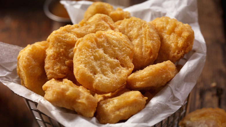 Fried chicken nuggets in a metal basket