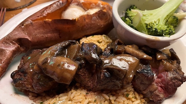 Texas Roadhouse filet medallions with mushroom sauce and sides of baked sweet potato and broccoli