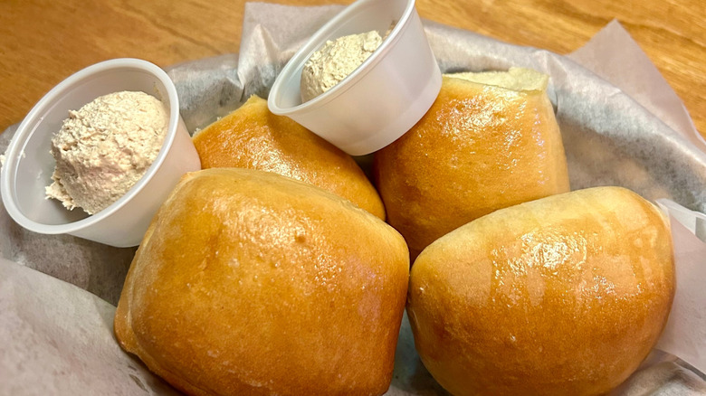 Texas Roadhouse rolls with plastic cups of butter