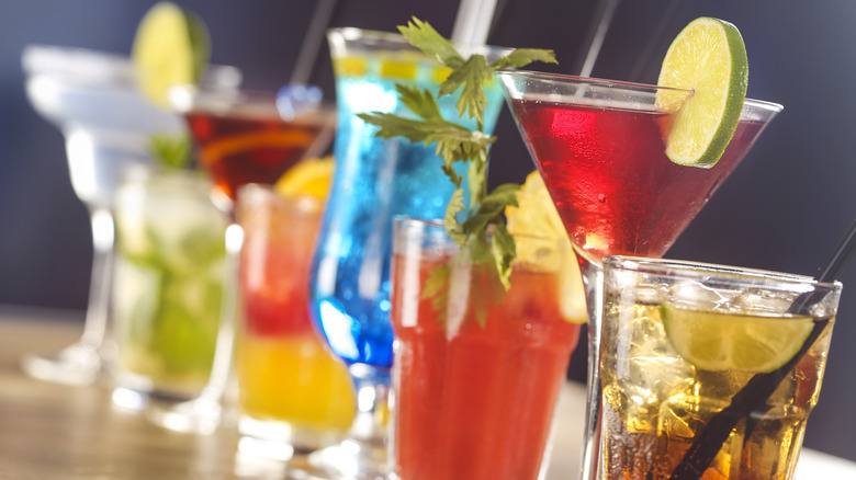Various colorful cocktails lined up.