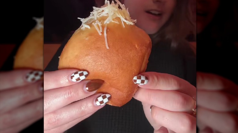 A Texas Roadhouse roll topped with garlic butter and parmesan.