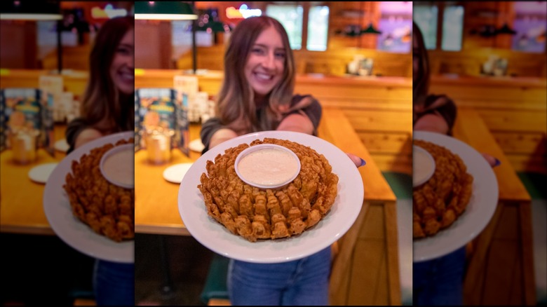 Woman holding a Texas Blossom appetizer at Texas Roadhouse