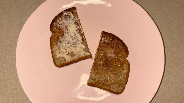 A piece of toast cut in half with different spreads on each side