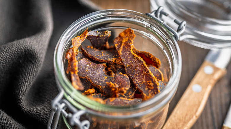 Glass jar of seasoned beef jerky