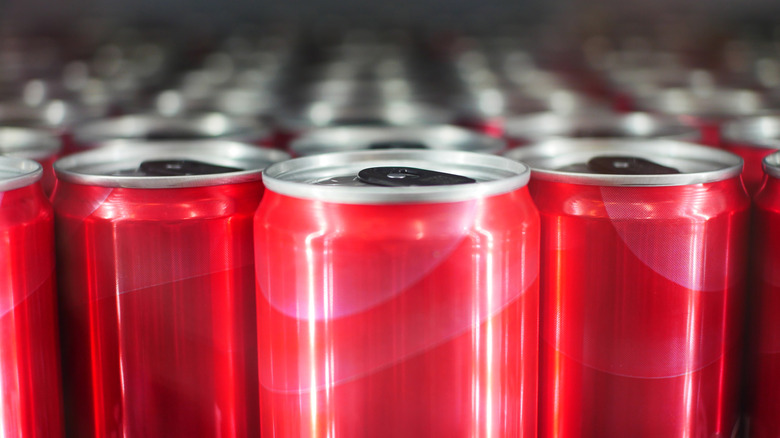 Red cans of energy drinks lined up