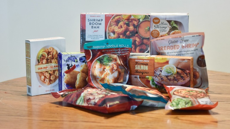 A collection of frozen seafood from Trader Joe's on a wooden table