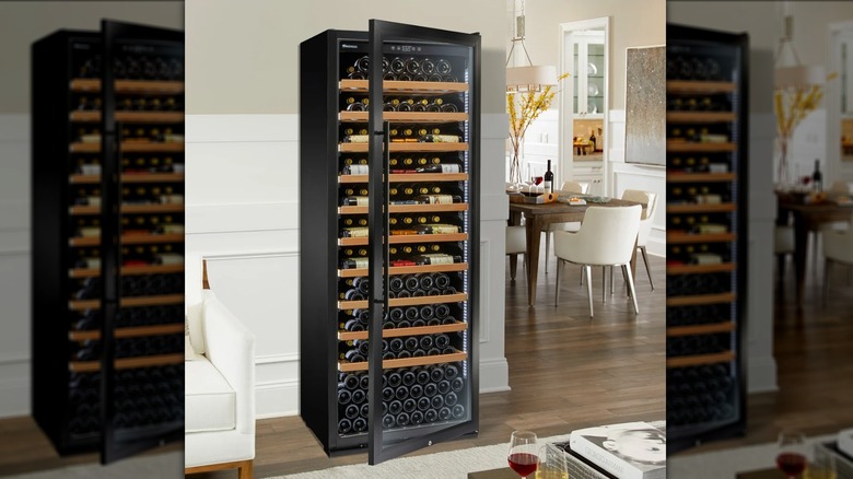 The Wine Enthusiast wine fridge standing upright, door partially adjar, in a white and beige home