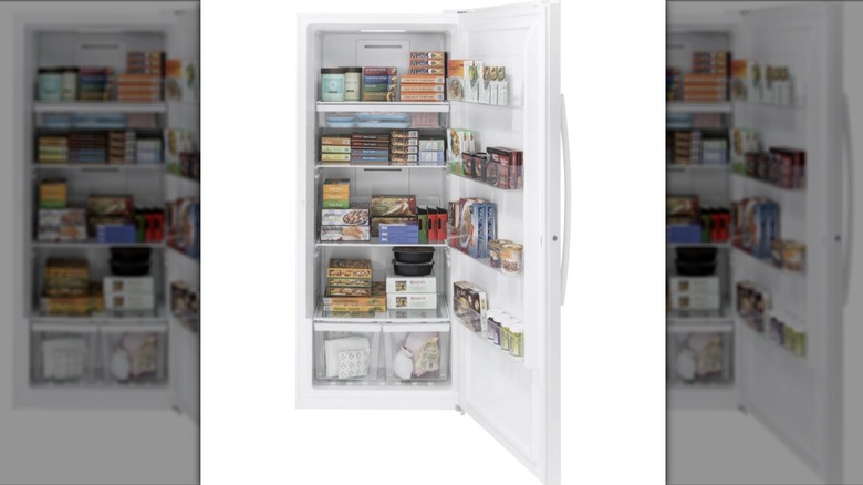 GE 21.3 cu. ft. garage-ready upright freezer with door open and items in freezer against a white background