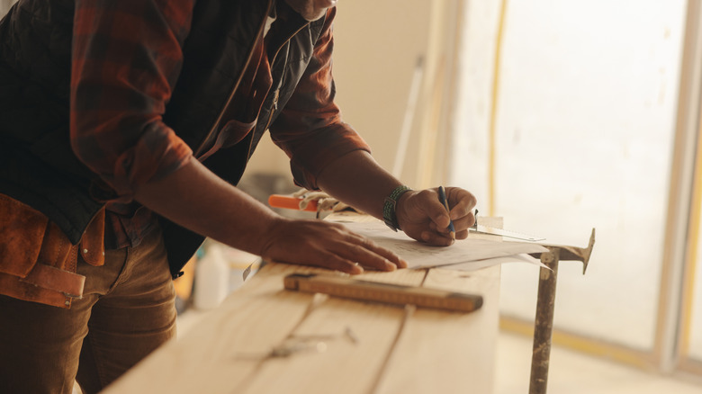 Marking blueprints in the kitchen