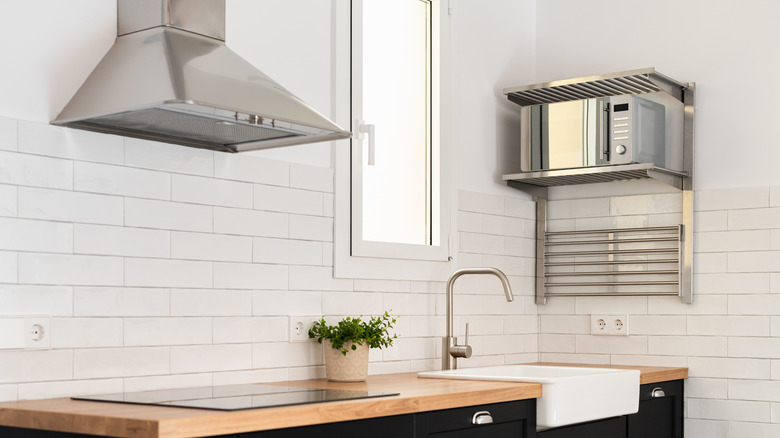 Oven hood on wall of subway tile