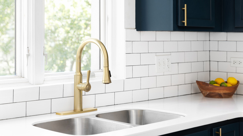 White kitchen backsplash with blue cabinetry