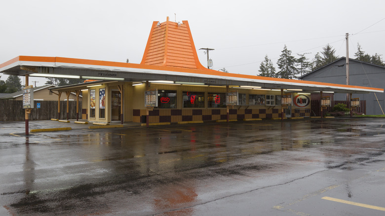 Older style A&W Restaurant with covered parking and a roof that's pointed in the middle