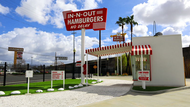 Replica of original In-N-Out showing drive-thru and sign with old prices
