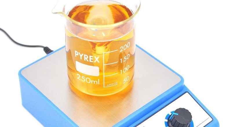 Beaker with liquid on magnetic mixer