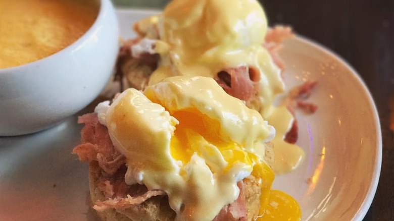 An eggs Benedict and cheddar grits from Posana