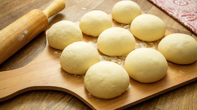 Balls of pizza dough on a board