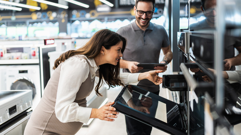 Person assisting customer shopping for appliances