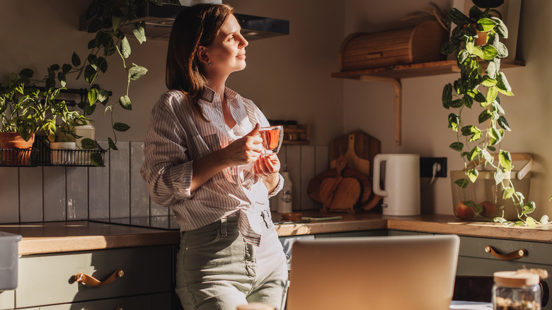 Woman drinking coffee in the kitchen