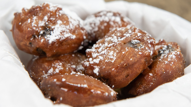 close-up of fried Oreos placed in basket with white tissues