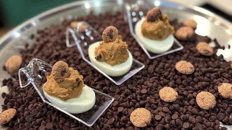 three deviled eggs filled with cookie dough on top of chocolate chips