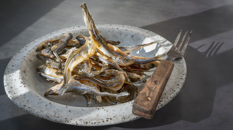 bowl smelt fish with fork