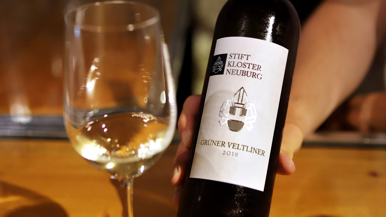 Hand holding bottle of Grüner Veltliner