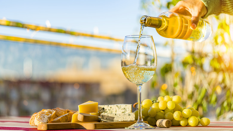 Hand pouring sauvignon blanc into a glass