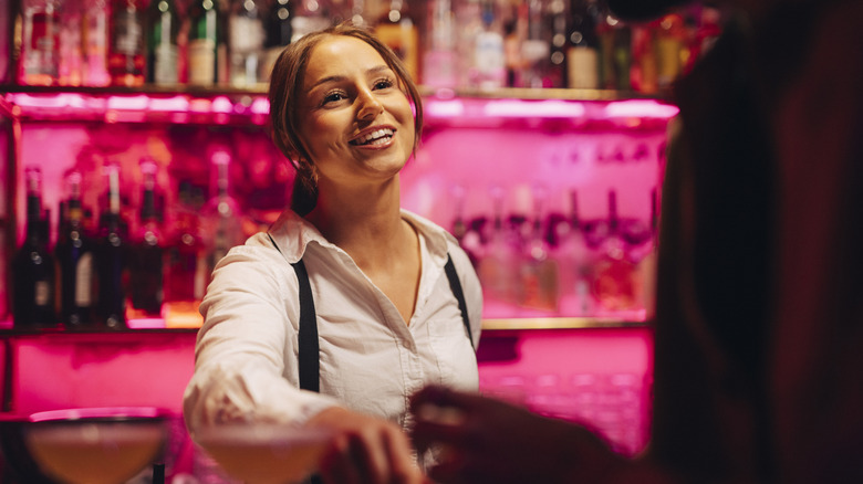 A bartender talks to a customer