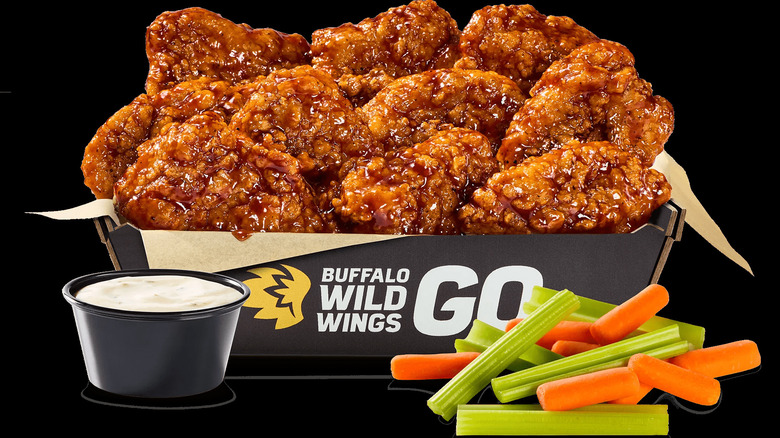 Buffalo Wild Wings boneless wings with veggies and ranch on black background