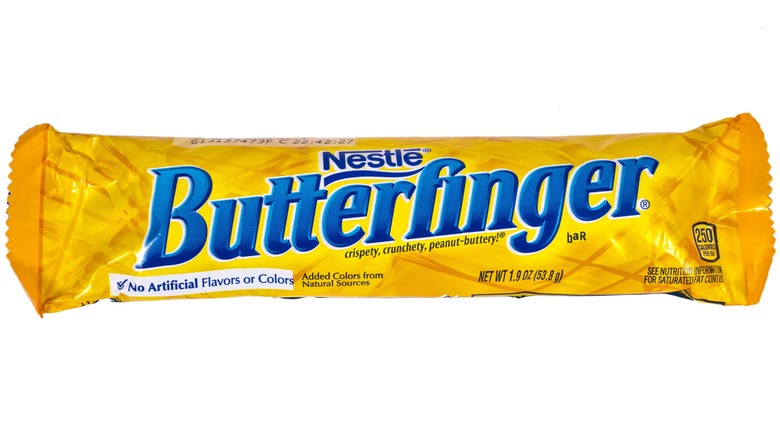 A Butterfinger bar peeks out of its wrapping