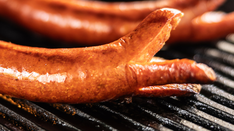 split sausages on grill