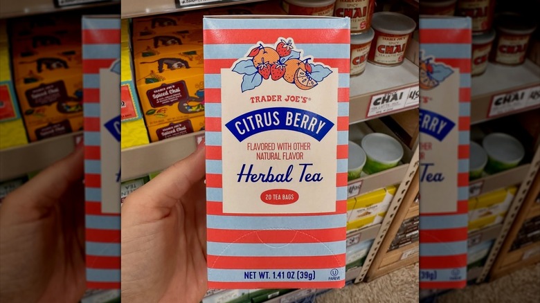 Trader Joe's citrus berry herbal tea in front of shelf.