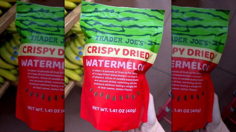 Hand holding a bag of Trader Joe's Crispy Dried Watermelon