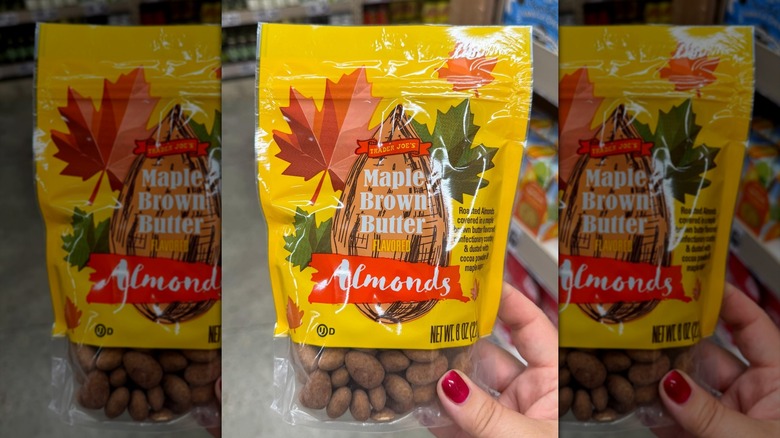 Hand holding a bag of Trader Joe's Maple Brown Butter Almonds