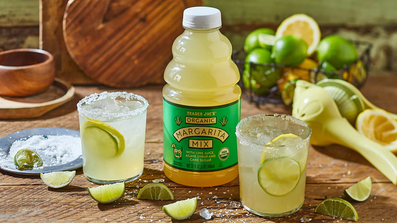 Trader Joe's Organic Margarita Mix with mixed drinks on a wooden table