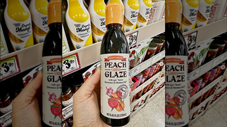 Hand holding a bottle of Trader Joe's Peach Flavored Glaze