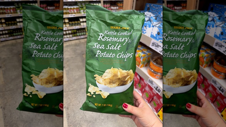 Hand holding a bag of Trader Joe's Rosemary & Sea Salt Potato Chips