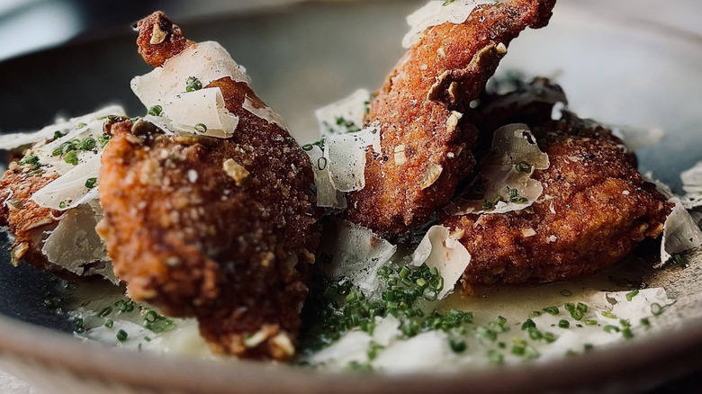 Fried quail with shaved cheese and thinly sliced green onions